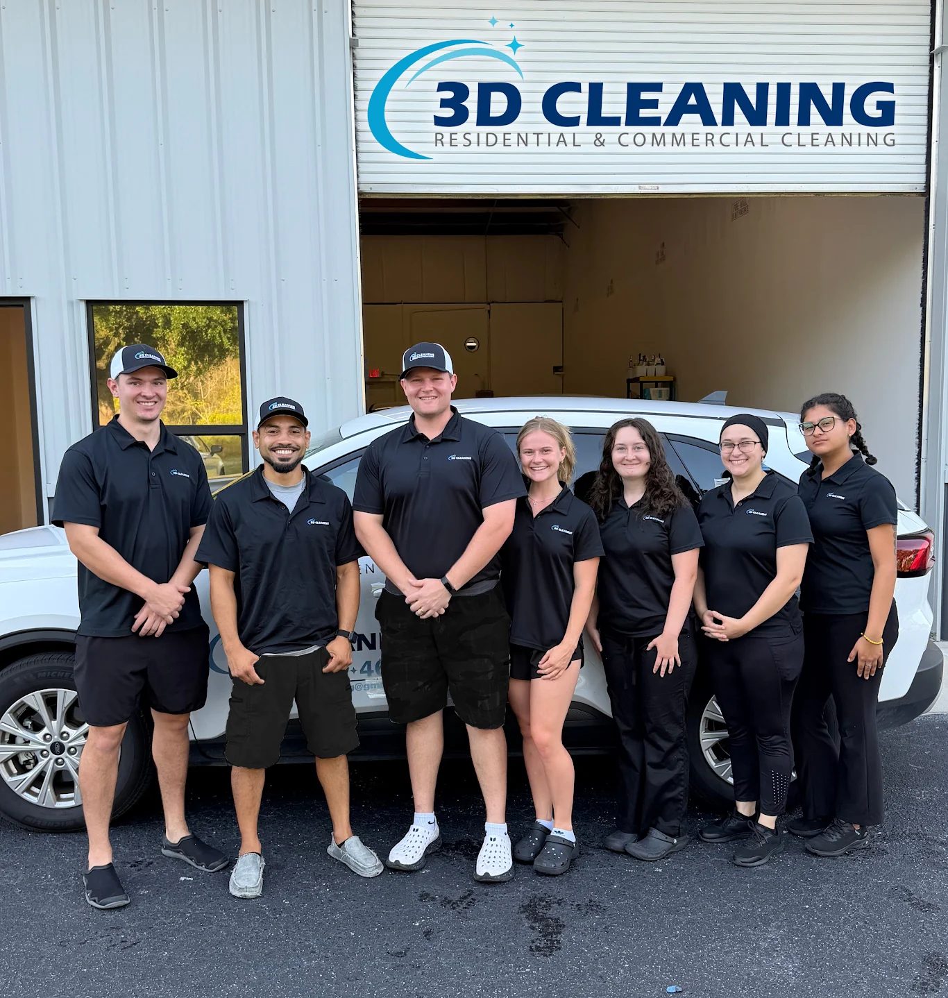 Seven members of the 3D Cleaning team beside a branded vehicle